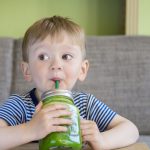 boy drinking green juice